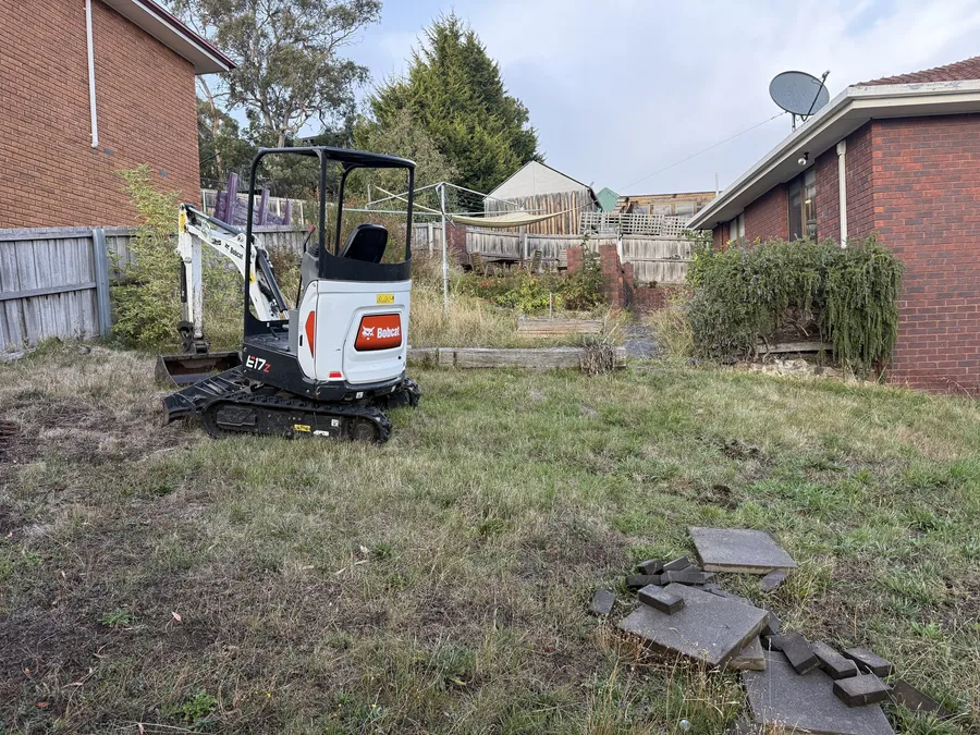 Before: the excavator arrives on the tired, dried-out back lawn