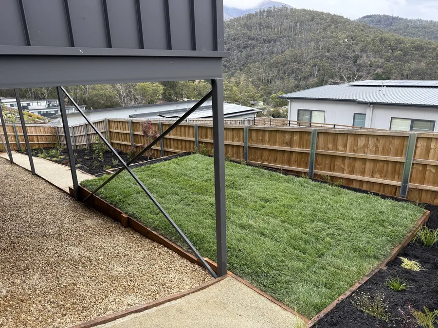 New turf laid inside timber edging on the hillside block