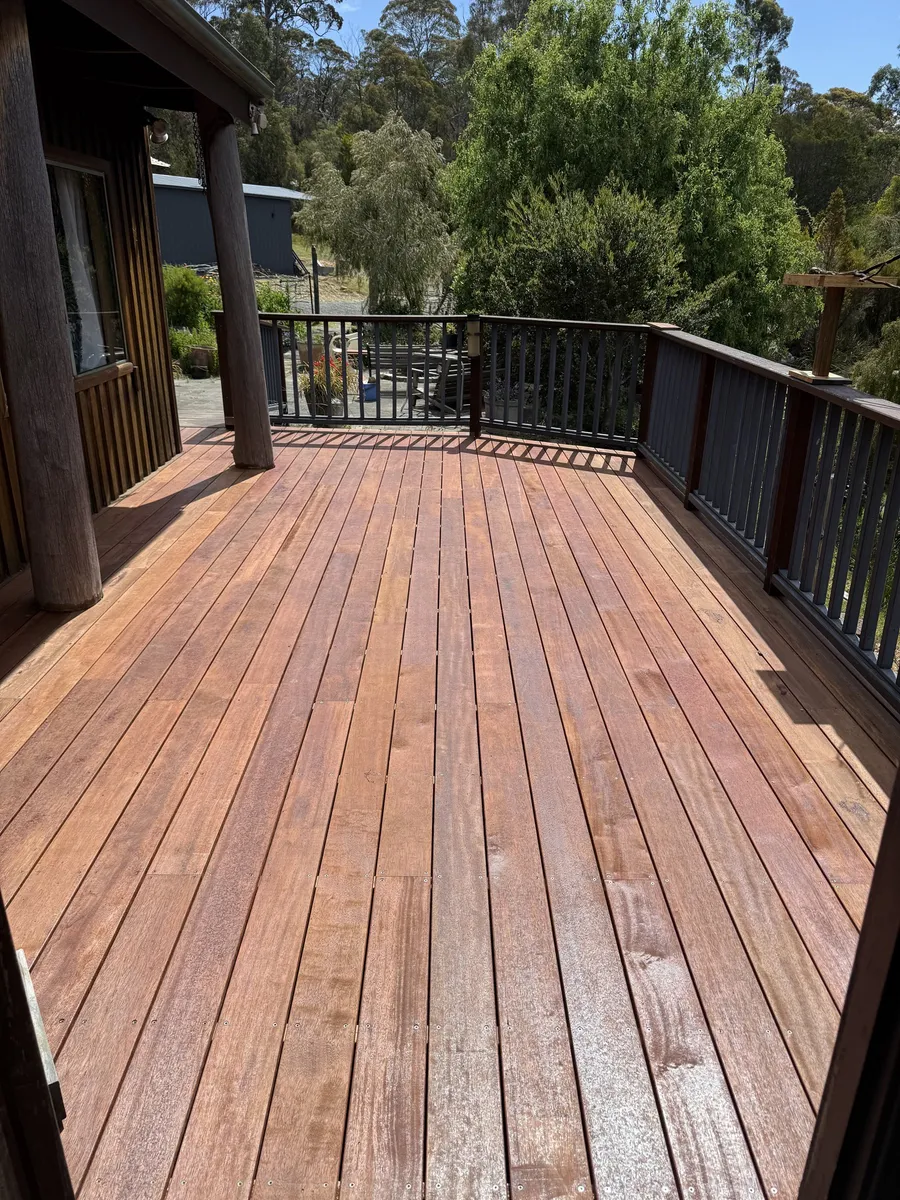 Fresh hardwood deck boards with the bush outlook beyond the balustrade