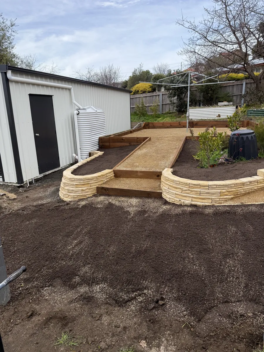 Sandstone raised beds and gravel terrace with the yard levelled and topsoiled
