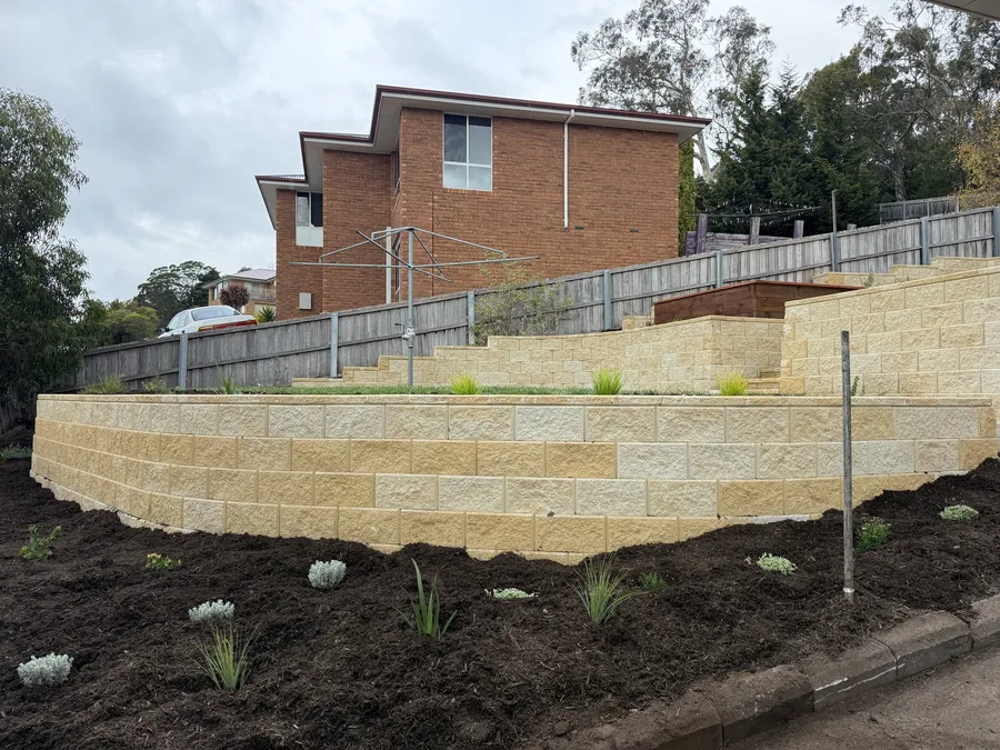 After: the terraced walls stepping down the hillside, freshly planted