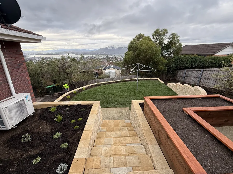 After: looking down the terraces to the lawn and clothesline, with views over Hobart