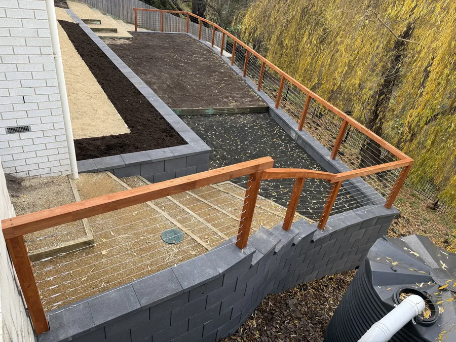 Looking down over the finished terraces, balustrade and fresh garden beds